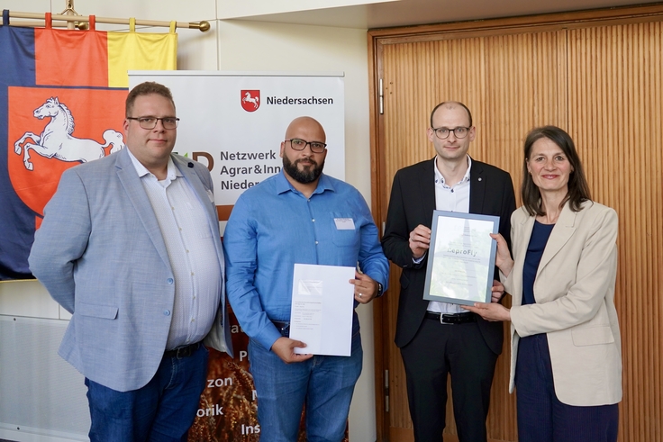 Landwirtschaftsministerin Miriam Staudte (rechts) übergibt den Bescheid für die EIP-Förderung an das Projekt „ReproFly“.