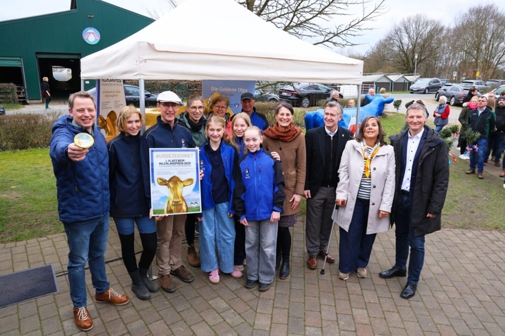 Ein Foto zeigt Ministerin Miriam Staudte bei der Aufstellung der "Goldenen Olga" gemeinsam mit Familie Diers und weiteren Ehrengästen